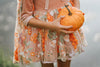 Boutique kids costume dress with matching floral cape and pumpkin tones – fairy-inspired twirl dress for fall celebrations