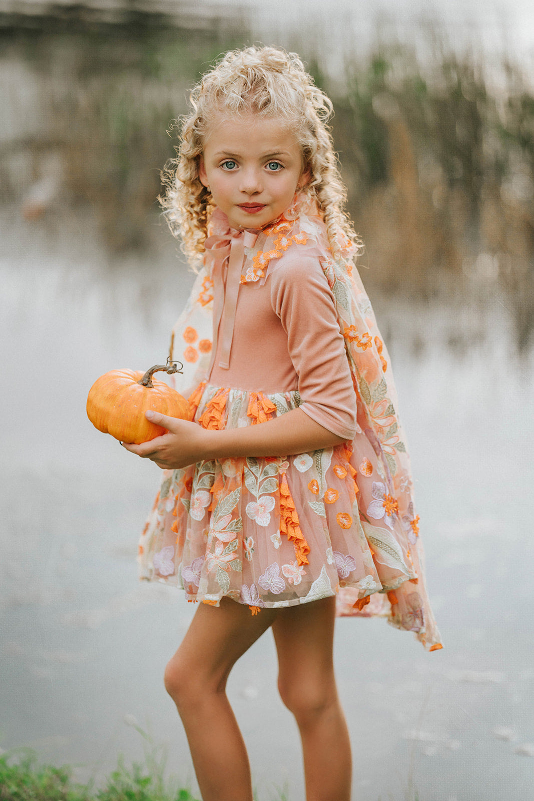 Girls Halloween dress-up outfit featuring fairy cape and pumpkin-themed tutu – whimsical fall fashion for children