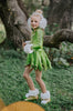 Girls metallic green coat dress with jeweled buttons and gold trim, displayed on mannequin against white brick wall

Shiny green holiday dress for girls with flared skirt, lapel collar, and crystal floral buttons, perfect for Christmas or pageants

Tinkerbell-inspired metallic green coat-style dress for girls, featuring pleated skirt and jeweled embellishments
