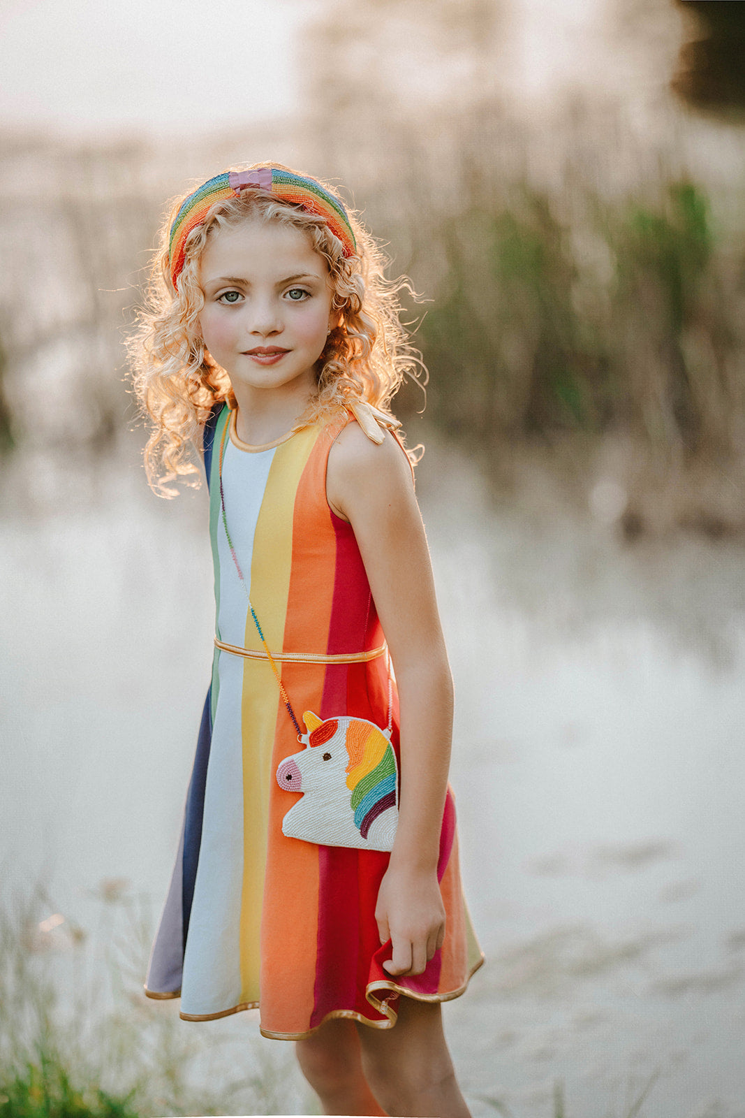 Hand-beaded kids unicorn crossbody purse in rainbow colors with matching rainbow accessories on white background