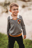 Toddler boy dressed in Gryffindor-inspired wizard shirt with crest and collar, holding wand and smiling outdoors

Young boy wearing wizard costume top with gold and red striped accents and crest patch, perfect for Halloween or dress-up

Wizard-themed boys shirt with collar and house crest, inspired by Harry Potter, styled for magical play or school events