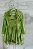 Girls metallic green coat dress with jeweled buttons and gold trim, displayed on mannequin against white brick wall

Shiny green holiday dress for girls with flared skirt, lapel collar, and crystal floral buttons, perfect for Christmas or pageants

Tinkerbell-inspired metallic green coat-style dress for girls, featuring pleated skirt and jeweled embellishments

Emerald green girls dress with long sleeves and coat silhouette, styled with gold piping and crystal button accents