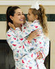 Mom and daughter wearing matching dinosaur pajamas in red, blue, and green print, cuddling and smiling in cozy indoor setting

Matching mommy and me dinosaur pajama set with colorful dino print, perfect for bedtime, holidays, or family photos

Mother and child snuggling in coordinating white dinosaur print pajamas with red piping, styled for cozy family moments