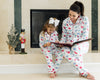Mom and daughter wearing matching dinosaur pajamas in red, blue, and green print, cuddling and smiling in cozy indoor setting

Matching mommy and me dinosaur pajama set with colorful dino print, perfect for bedtime, holidays, or family photos

Mother and child snuggling in coordinating white dinosaur print pajamas with red piping, styled for cozy family moments