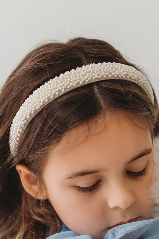 The all over pearl headband has dainty ivory pearls.  Just under 1" wide it is comfortable for all day wear. 