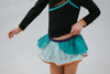 A young girl is wearing a 2 piece long sleeve rash guard swim set. The top is black with turquoise and goldenrod accents. The bottom has a turquoise ruffle over a mint teal skirt with goldenrod hem accent. 