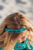 The Arabian Princess Headband is a bright teal with royal blue and emerald green jewels.  They are designed in ornate patterns.  The headband is approximately an 1" wide. 