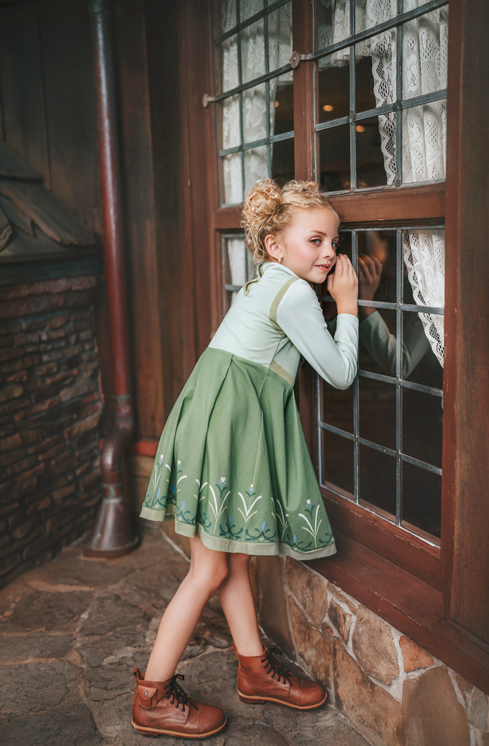 For the first time in forever....a long sleeve cotton twirl dress in spring greens.  The bodice is adorned with 6 buttons and iridescent ribbon. There is a faux vest look and the skirt is a bright earthy green with floral pattern on the hem. Perfect for getting out of the castle. 