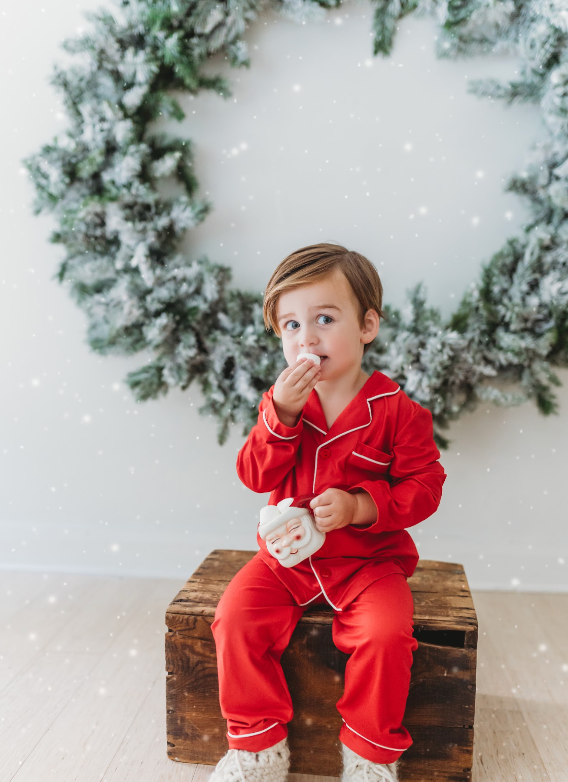 A young child is dressed in the buttery soft Unisex Pj's in Red from our Christmas Lounge Collection. The true Christmas red pajamas have a classic design.  They are piped with white trim.  The 2 piece pj set is perfect for photos and warm cozy holiday cheer. 