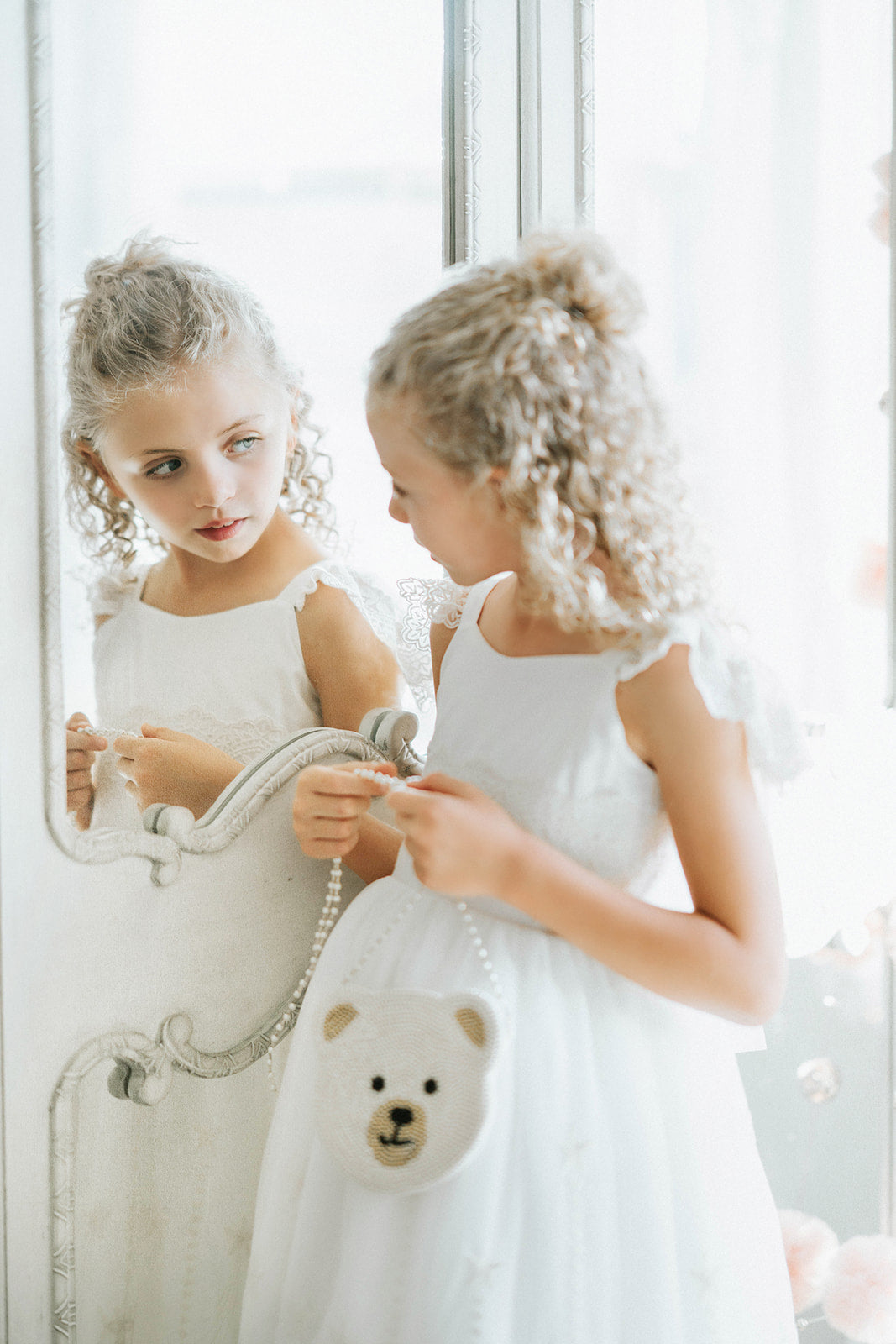 White beaded teddy bear purse with pearl crossbody strap hanging on a lace flower girl dress, perfect for toddlers and formal events

Close-up of teddy bear face purse made with pearl beads, styled with an elegant white dress for a wedding or birthday