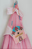 Beaded pink castle purse hanging on a pink princess dress, perfect for little girls’ dress-up and birthday gift ideas