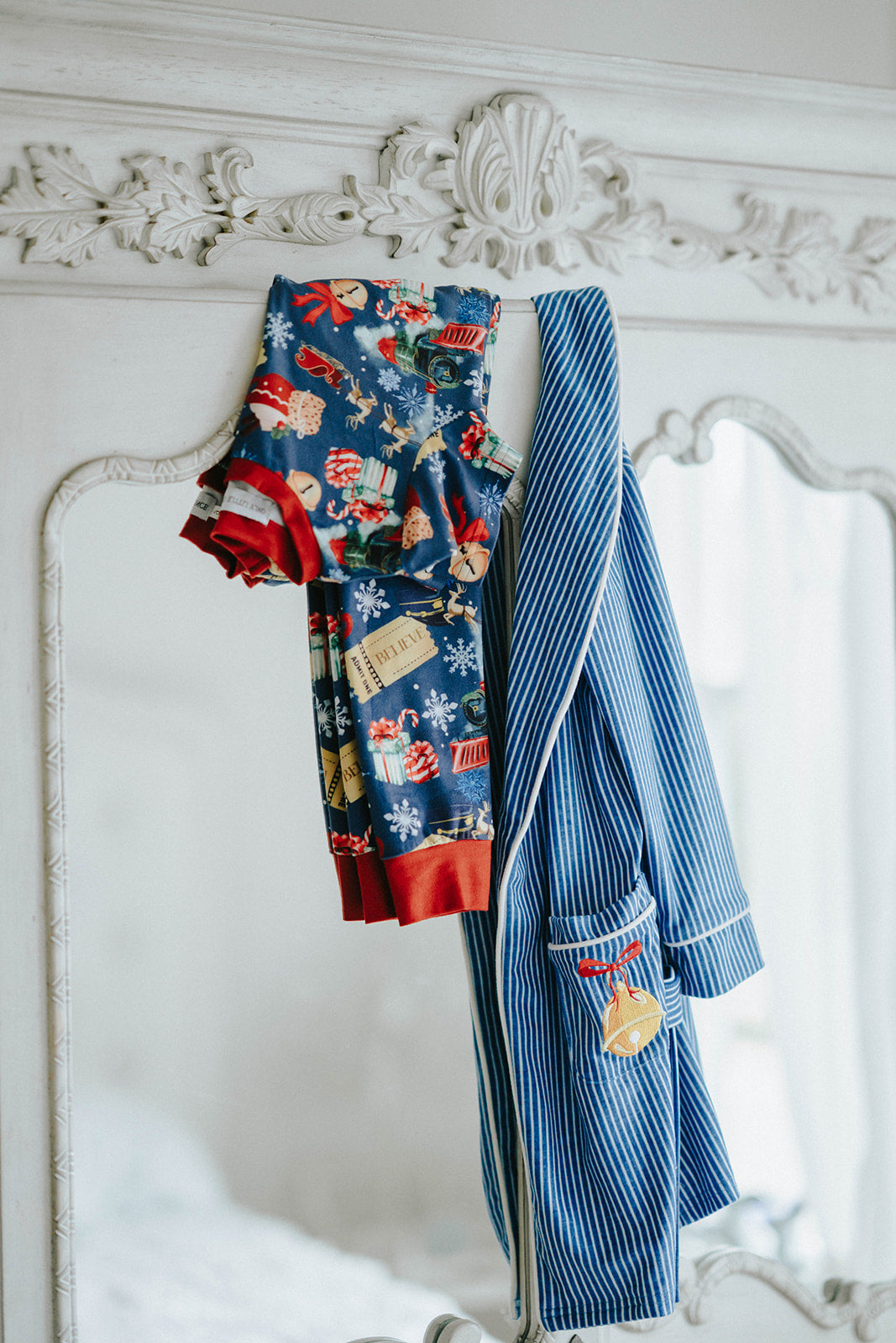 Close-up of child wearing blue striped Polar Express robe with gold bell embroidery on pocket and cozy Christmas pajamas underneath

Kids holiday robe inspired by Polar Express with white piping, gold bell patch, and tie waist, styled for Christmas morning

Blue and white striped Christmas robe with gold bell detail, worn by child with cozy holiday pajamas and slippers

Polar Express-themed unisex robe with gold bell embroidery and piping trim, perfect for kids’ Christmas sleepwear