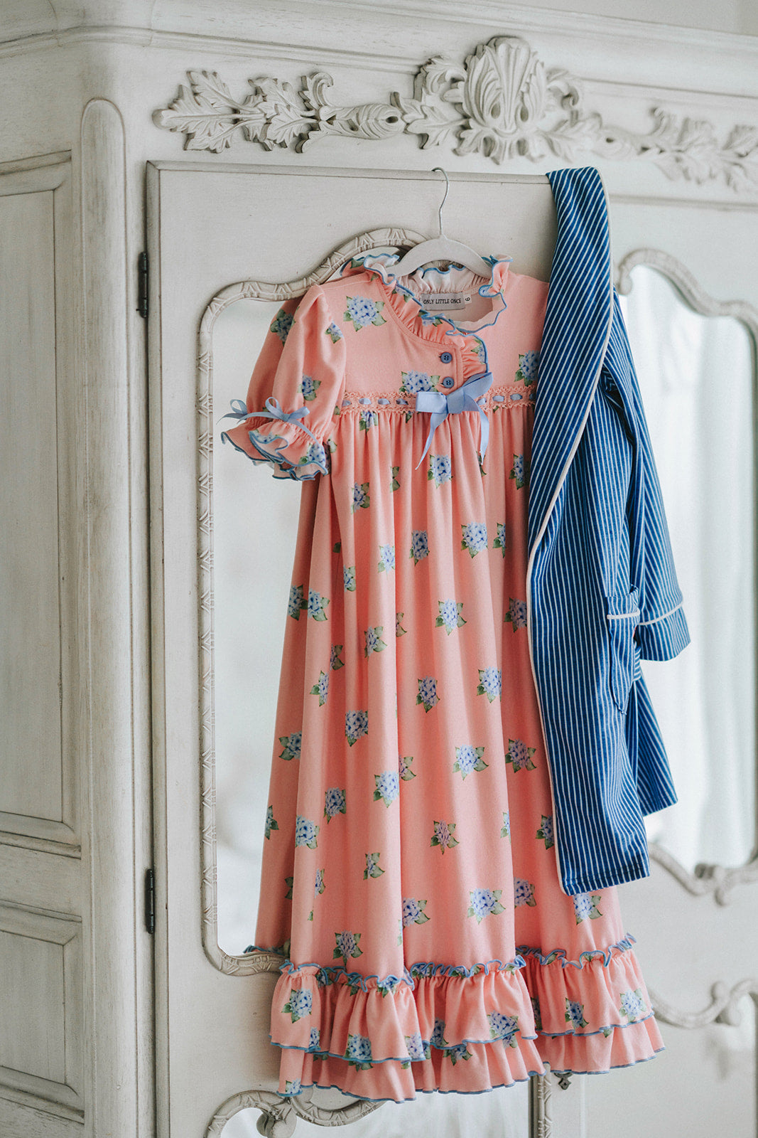 Close-up of child wearing blue striped Polar Express robe with gold bell embroidery on pocket and cozy Christmas pajamas underneath

Kids holiday robe inspired by Polar Express with white piping, gold bell patch, and tie waist, styled for Christmas morning

Blue and white striped Christmas robe with gold bell detail, worn by child with cozy holiday pajamas and slippers

Polar Express-themed unisex robe with gold bell embroidery and piping trim, perfect for kids’ Christmas sleepwear