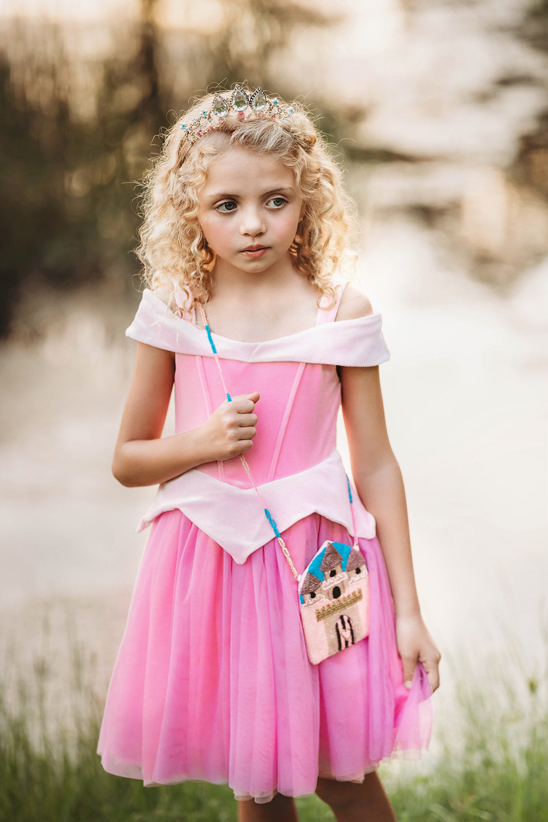 Fairytale castle crossbody purse for girls with beaded details, styled with pink velvet and tulle dress for magical playtime