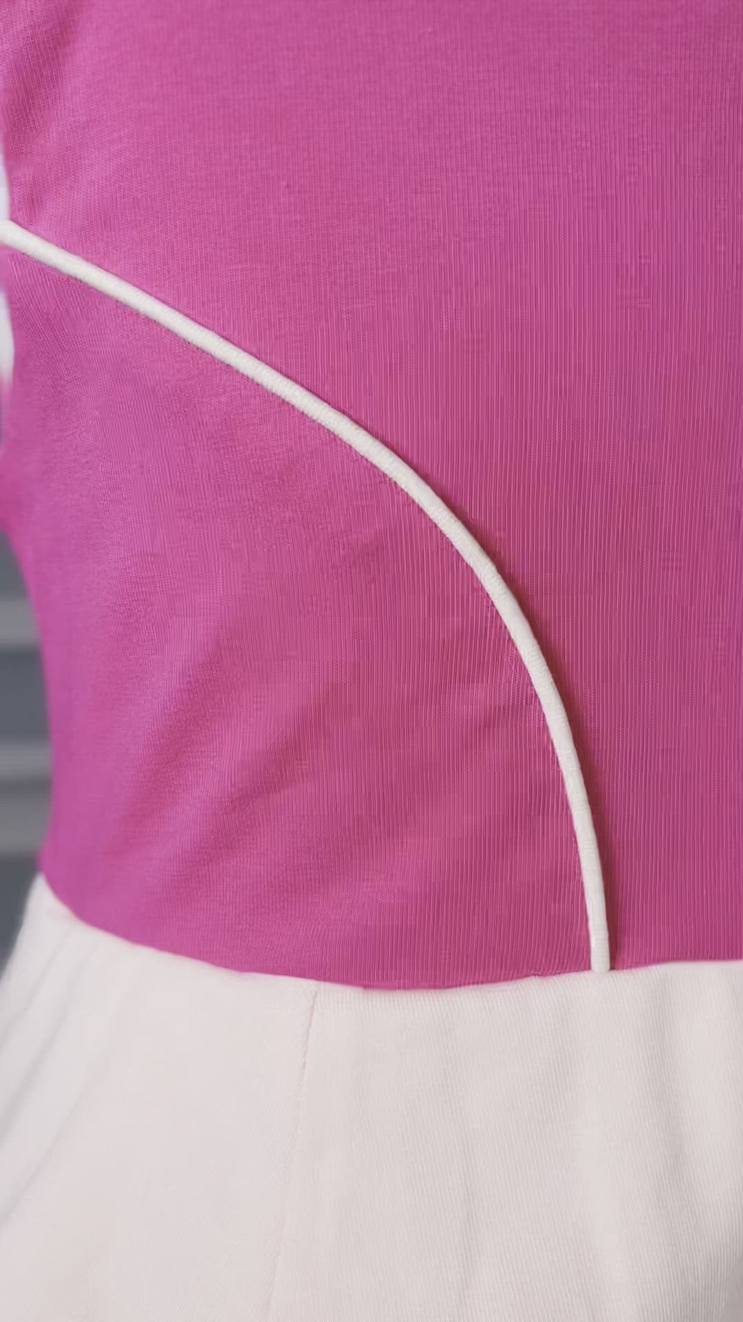 The neckline has nude mesh and light pink sits off the shoulder.  The bright pink bodice has light pink piping and leads into a light pink handkerchief band.  The skirt is flowy and bright pink.  A light pink ruffle at the hem line adds a beautiful twirl. 