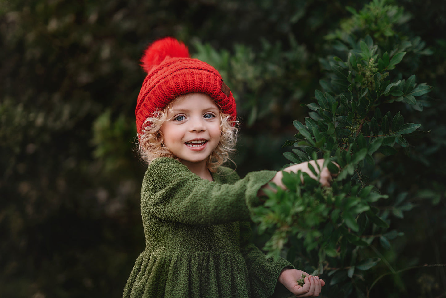 Empire waist dress in an earthy green color. Made with ultra soft chenille fabric that creates a faux-fur look.  Lined in a stretchy and soft polyester. Long sleeve with ruffle belle at bottom of the sleeve.  