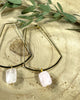 Golden hoops rectangle shape hoops with a rose quartz faceted stone that dangles from the bottom. 