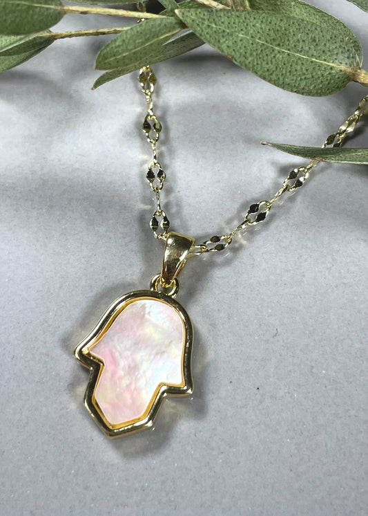 A golden chain with golden hamsa design inlayed with mother of pearl.