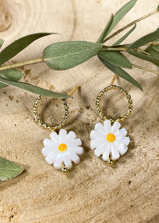 Small golden circles set on posts.  A petite daisy charm dangles from the gold hoop. 