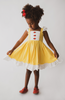 A young girl is wearing our Original Red Rose Twirl Dress from the Princess Twirl Collection. The sleeveless yellow dress features white ruffled trim and three red roses down the front. The sunny yellow dress provides a perfect princess twirl and soft comfortable cotton fabric. 