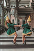 A young girl stands wearing the Smiling Elf Dress, adorned with yellow embroidery, a white collar, and a yellow hem. She also sports a matching yellow cone hat.